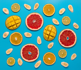 Tropical fruit slices on blue background