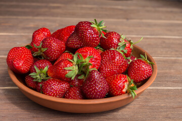 Red ripe big homemade strawberry close-up. A healthy summer berry.