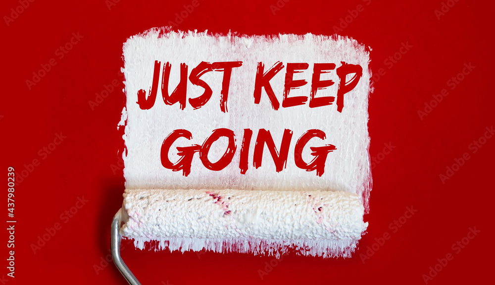 Poster just keep going .one open can of paint with white brush on it on red background. top view.