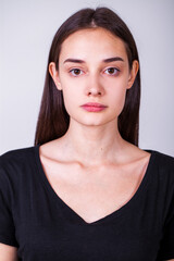 Close up portrait of a young beautiful girl isolated on gray background