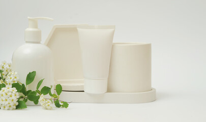  Podium of geometric shapes with cosmetic product on white background 