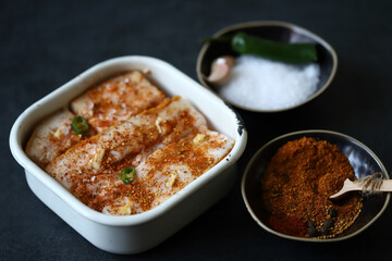 Lard with spices in a bowl. Salting lard.