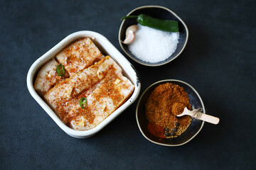 Lard with spices in a bowl. Salting lard.