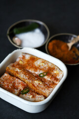 Lard with spices in a bowl. Salting lard.