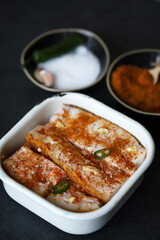 Lard with spices in a bowl. Salting lard.