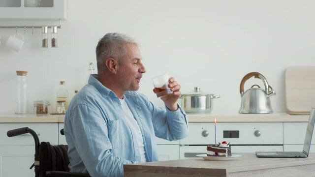 Happy Disabled Man Celebrating Birthday Communicating Online At Home