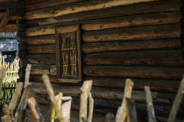 Fototapeta na wymiar Wall of a vintage wooden house with a window. Selective focus