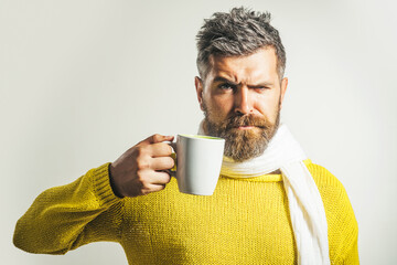 Taking coffee break. Stylish man drinks cup of cappuccino. Handsome bearded male with mug of tea.