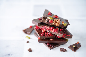 Obraz na płótnie Canvas Handmade dark chocolate with berries and nuts