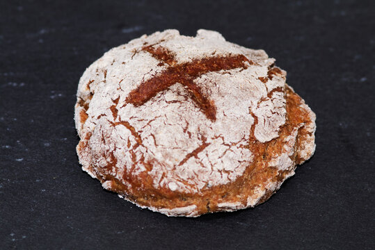 Rye Roll with flour on the black stone from bakery