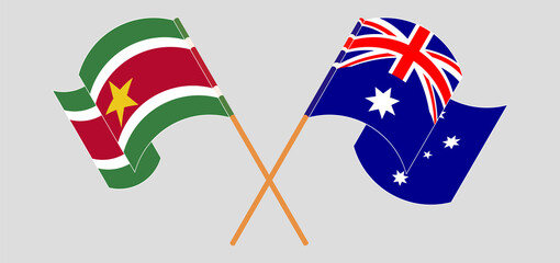 Crossed and waving flags of Suriname and Australia