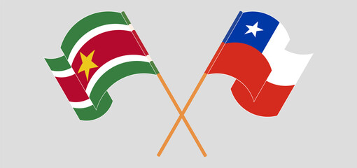 Crossed and waving flags of Suriname and Chile