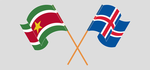 Crossed and waving flags of Suriname and Iceland