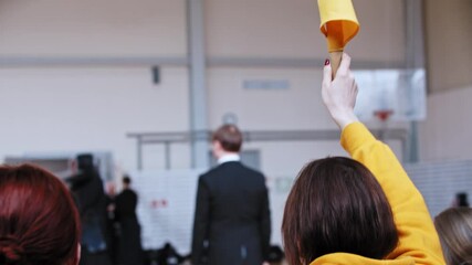 Kendo tournament - woman showing a yellow flag - Powered by Adobe
