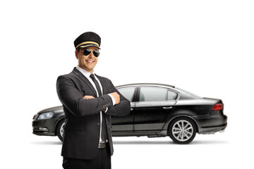 Chauffeur with sunglasses posing in front of a black car