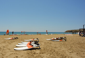 Prasonisi, Greece 05-31-2021 mediteranean sea, surf equipment and surfbords on a beach