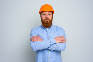 Isolated confidant architect with beard and orange helmet