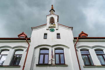 Facade of an old building with a tower and a bell