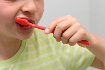 Child brushes his teeth with a toothbrush