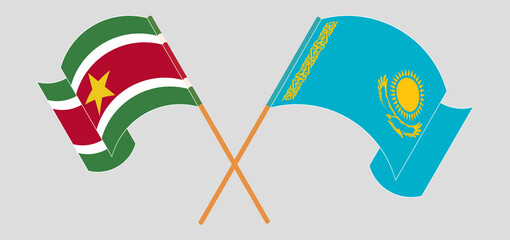 Crossed and waving flags of Suriname and Kazakhstan