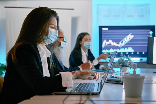 A woman sitting at a table with a laptop