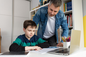 Father helping son finish homework