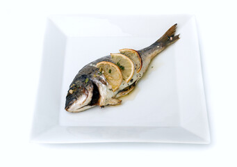Fish baked with lemon, on a plate on a white background