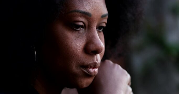Sad pensive black woman close-up face feeling depressed and preoccupied