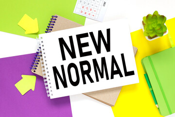 New Normal.notepad on a colorful background. white purple and yellow background.