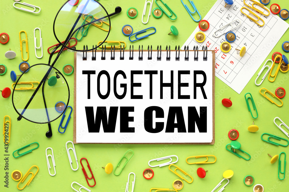 Poster together we can.text on notepad on bright green background. near paper clips and buttons