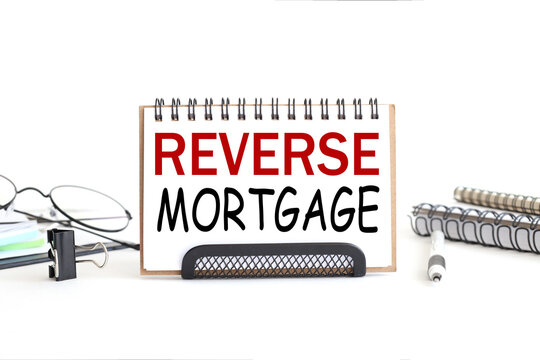 Reverse Mortgage. text on notepad. on a white background near the stationery