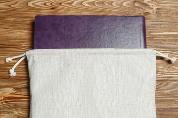photo book with a wooden surface with copy space for text.
purple photo album with 
notebook with leather cover.
photoalbum in a textile cover package.
photo book in fabric bag close up 