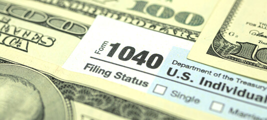Time to pay taxes, US dollar bills and 1040 US Individual income tax return form, banner