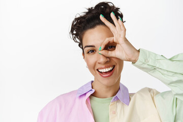 Close up of happy brunette woman shows OK okay gesture, smiling positive, praise and compliment,...