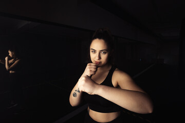Obraz na płótnie Canvas Portrait of a beautiful boxer girl with white hands