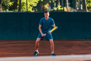 Focused male athlete waiting to receive the ball in a professional tennis game