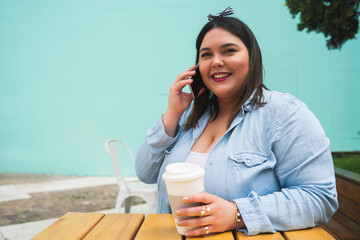 Young plus size woman talking on the phone.