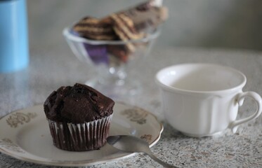 chocolate cookies with cup of coffee dessert spoon plate