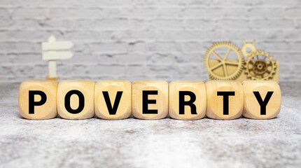 Poverty word written on wood block. Poverty text on wooden table for your desing, concept