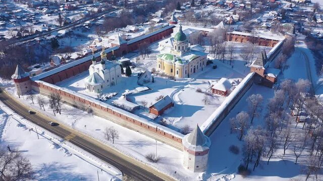View from drone of snow covered architectural ensemble of Zaraysk Kremlin with Forerunner and St. Nicholas cathedrals on winter day, Russia