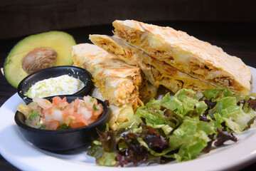delicious Mexican quesadilla with chicken stuffing and vegetable salad