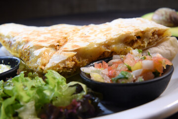 delicious Mexican quesadilla with chicken stuffing and vegetable salad