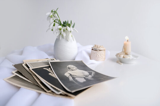 Stack Of Vintage Photos, Baby Photography Of 1960, Candle Is Lit, First Spring Flowers, Snowdrop, Galanthus In Vase, Concept Of Family Tree, Genealogy, Childhood Memories