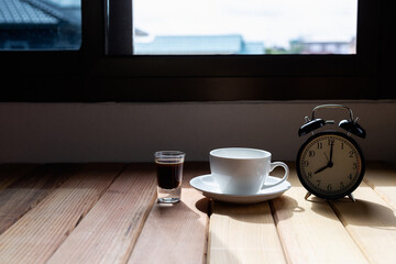 coffee cup and clock at the window