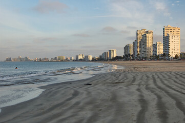 Panoramic view of the beach with buildings in  background in Salinas Ecuador at sunset