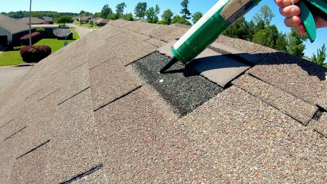 Repairing roof shingle damaged in storm