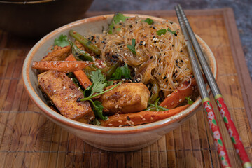 Vegan tofu and vegetables  stir fry  and bean thread noodles in serving bowl