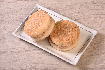 Rice burger with salmon, cheese on a white plate