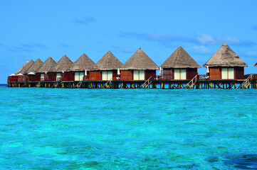Line of water villas at a resort in Maldivian sea