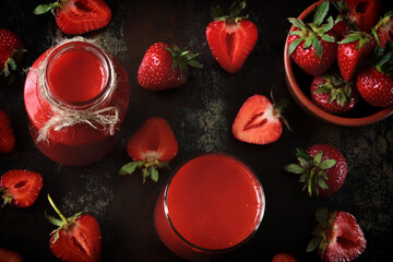 Fresh strawberry smoothies on a dark surface. Healthy summer detox.